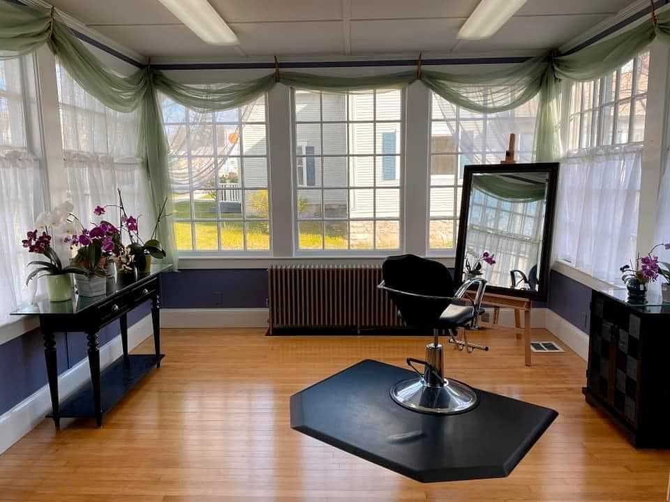 Bright and airy salon interior with a single styling chair and mirror.